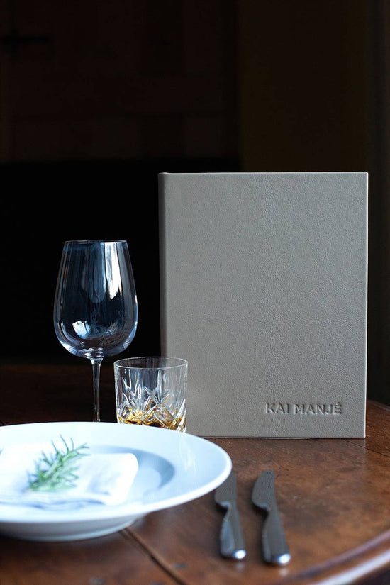 luxury leather bound menu cover with embossed logo in high end country setting