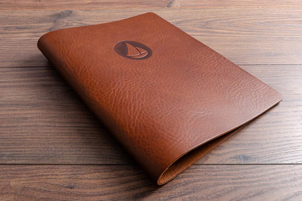 Brown leather screw post binder menu cover with a personalised logo of a boat embossed on the cover - Gallery image 5
