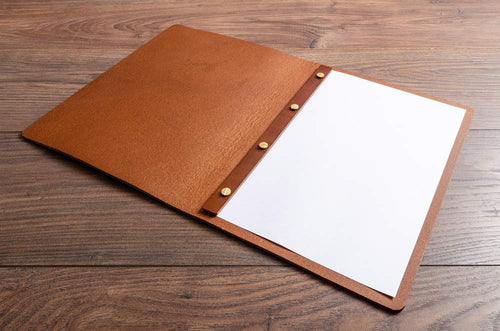 Brown leather screw post folder with a white sheet of paper inserted