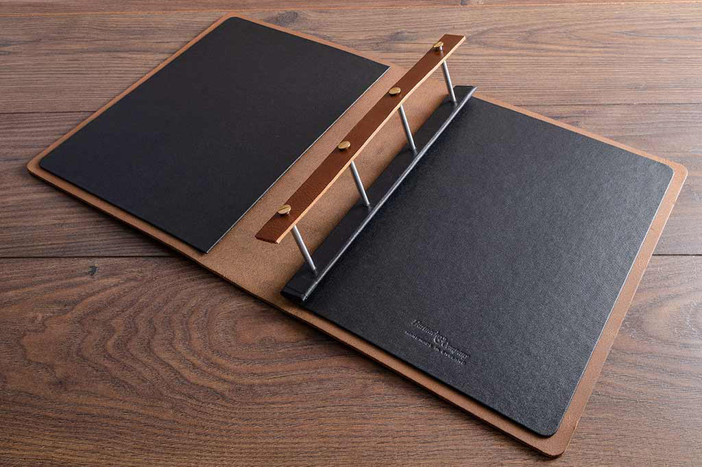 brown leather portfolio book with embossed logo on cover