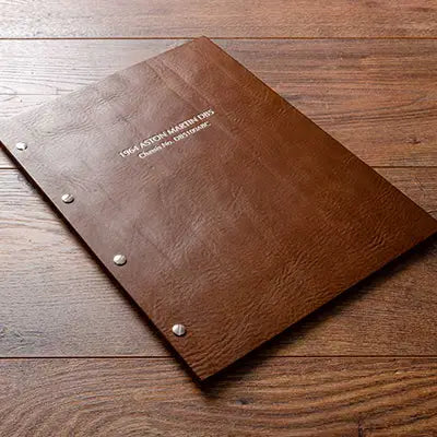 Brown leather screw post binder with silver foil personalisation.