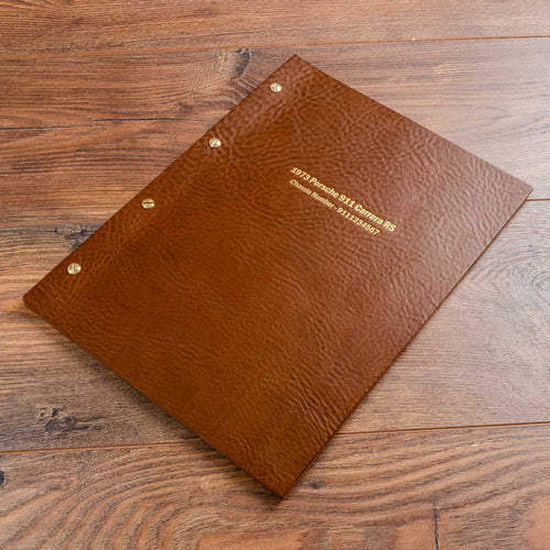 Brown leather screw post folder for a Porsche 911 with gold foil personalised cover