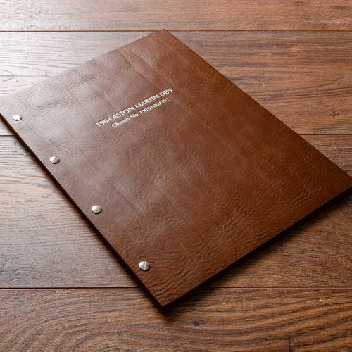 Brown leather screw post binder with silver foil personalisation.