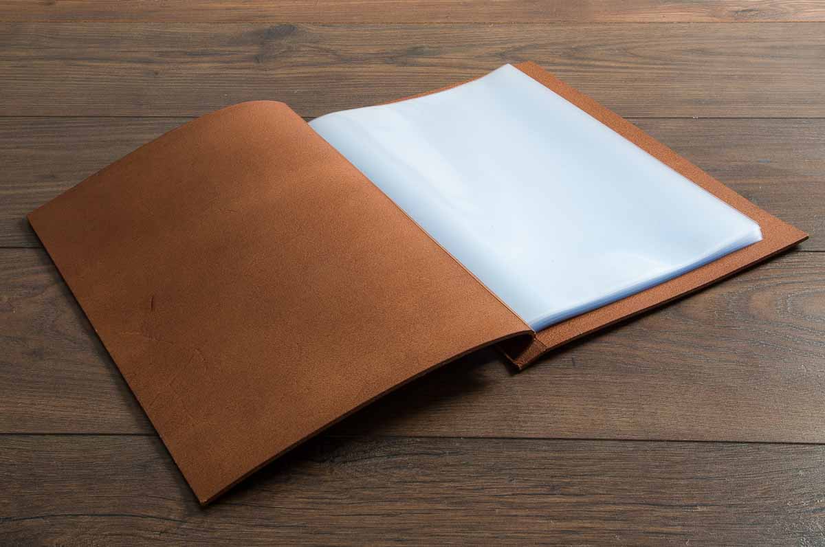 Leather exposed screw post binder open with plastic page protector pockets