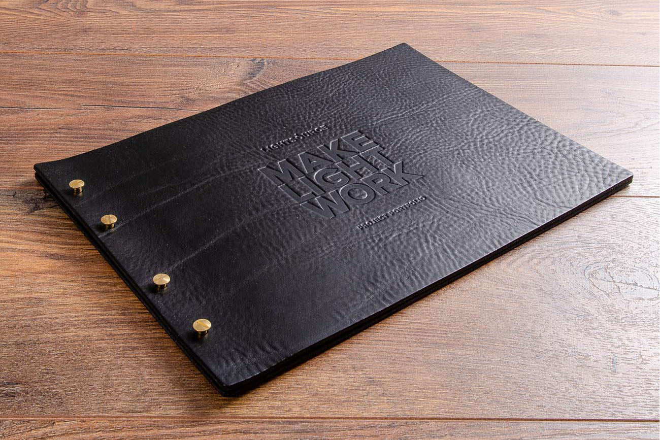 Leather portfolio book with blind debossed personalisation. Product is Hartnack & Co black leather exposed screw post binder