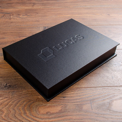 Black presentation clamshell box with blind embossed logo on the cover