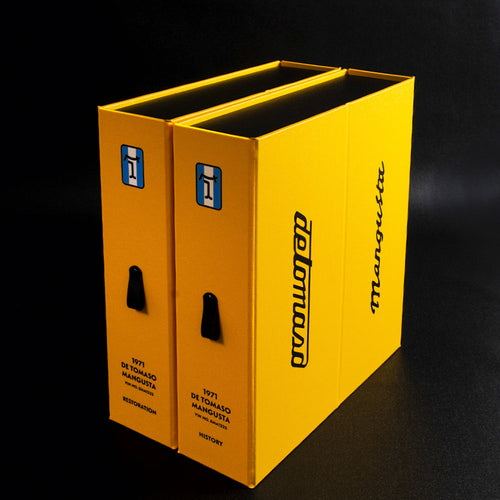 Two yellow personalised box files with De Tomaso Mangusta branding and car details for restoration and history documents 