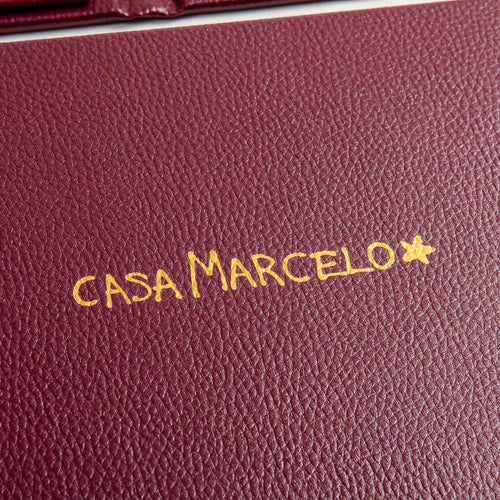 red leatherette menu cover with gold foil personalisation