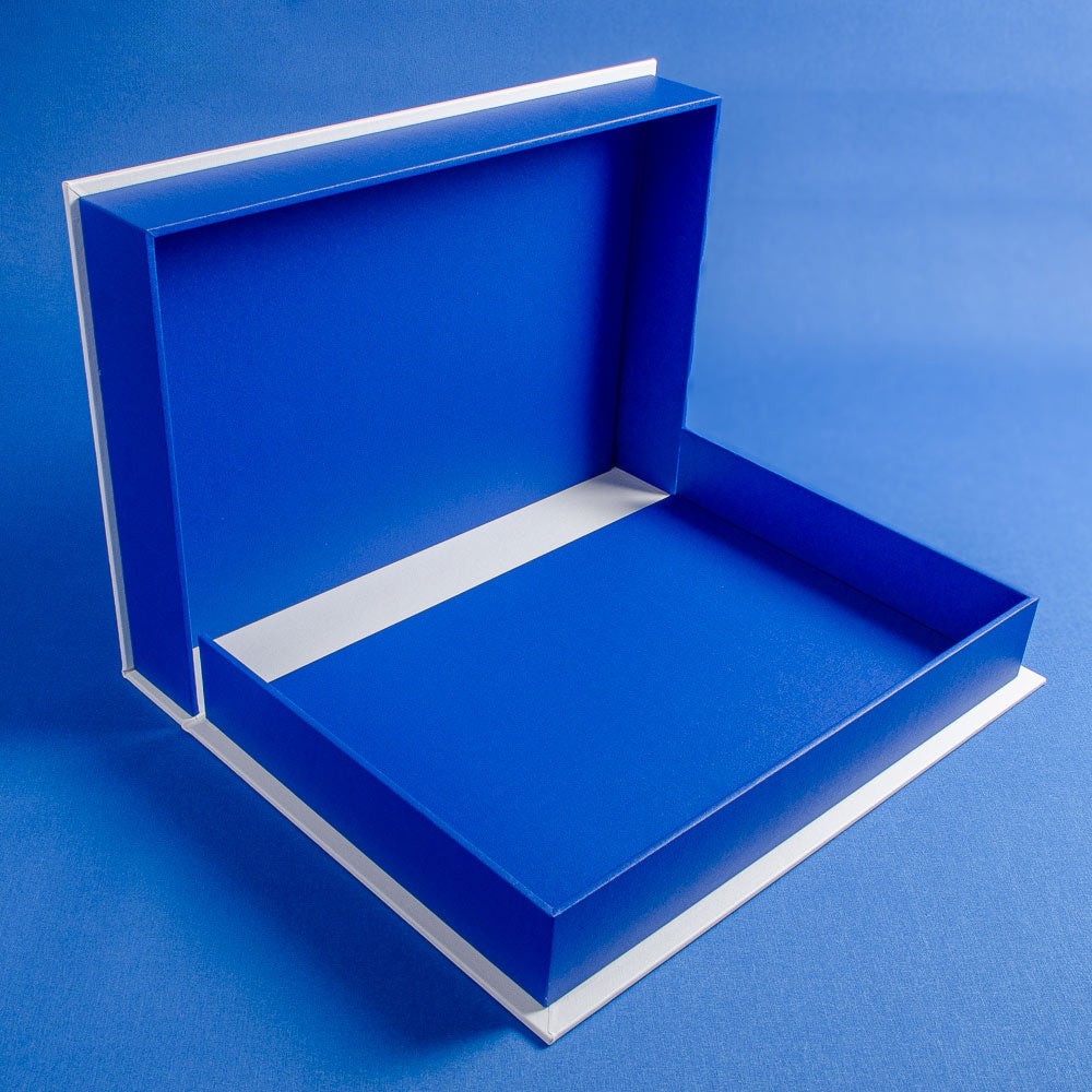 Blue luxury clamshell box with a white interior on a blue background - Gallery image 4