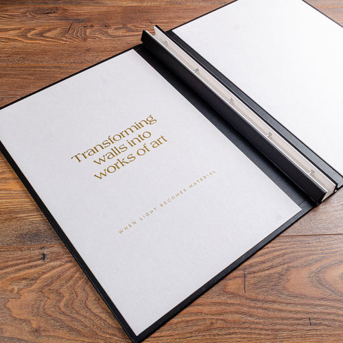 Inside cover of an A3 presentation screw post portfolio binder showing gold foil embossed logo and writing on the white inner cover