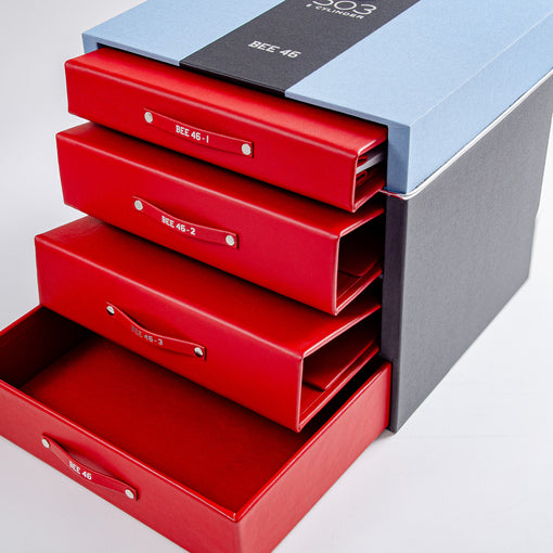 blue and black box with red binders and bmw 503 printed on top and car history folder 