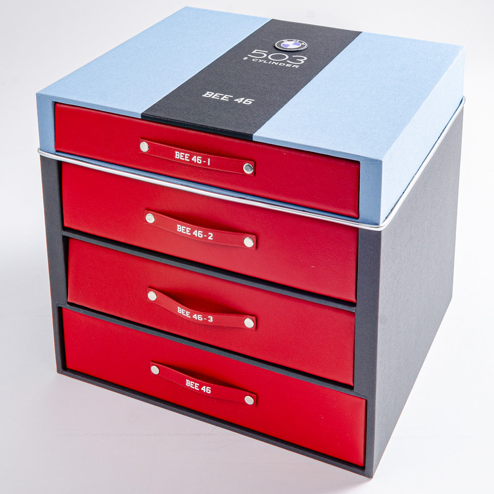 custom made box with silver foil embossing and bmw badge on top containing four red car history personalised binders - Gallery image 1