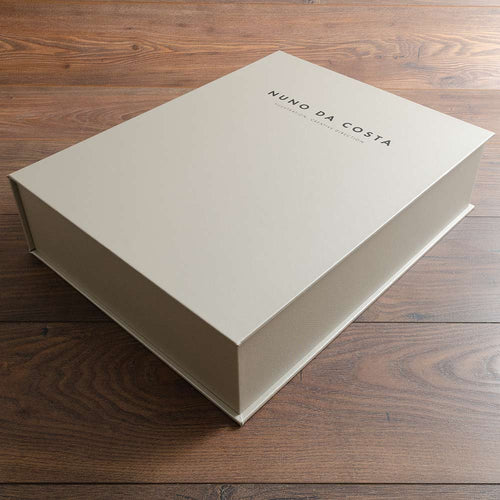 beige custom luxury clamshell box with black foil embossed personalised cover hand made by Hartnack and company