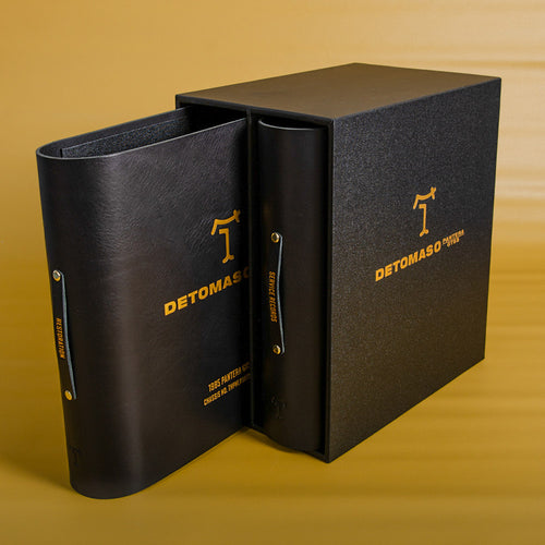 Black slipcase box with gold foil personalised cover and two leather ring binders for car service records and restoration