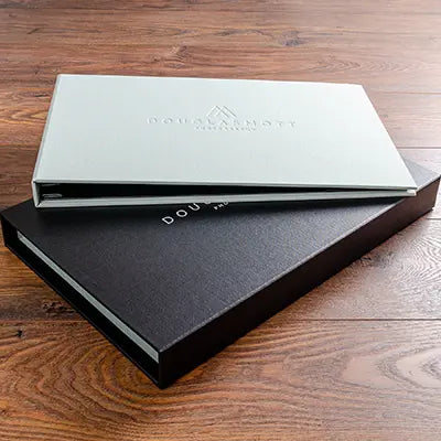 luxury landscape screw post presentation binder for photographer in green fabric with blind embossed cover on a black fabric slipcase