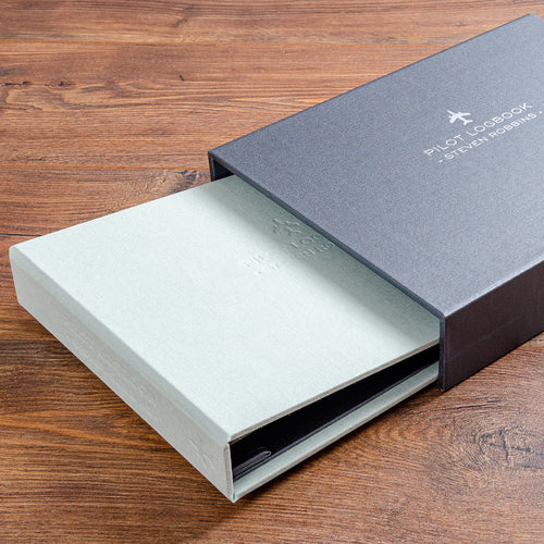 pilot logbook binder in green book cloth and personalised cover partly inside a grey personalised slipcase