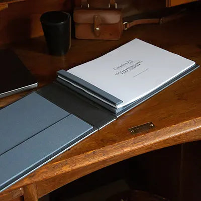 logten pilot logbook paper in a screwpost binder sitting on a wooden desk