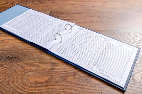 2 ring ringbinder lying open with the printed pages of the pilots flights