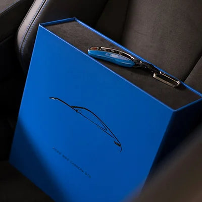 custom made blue box file with porsche key on top for car history and documents 