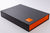 A3 portfolio box in charcoal and solo orange with personalised plaque