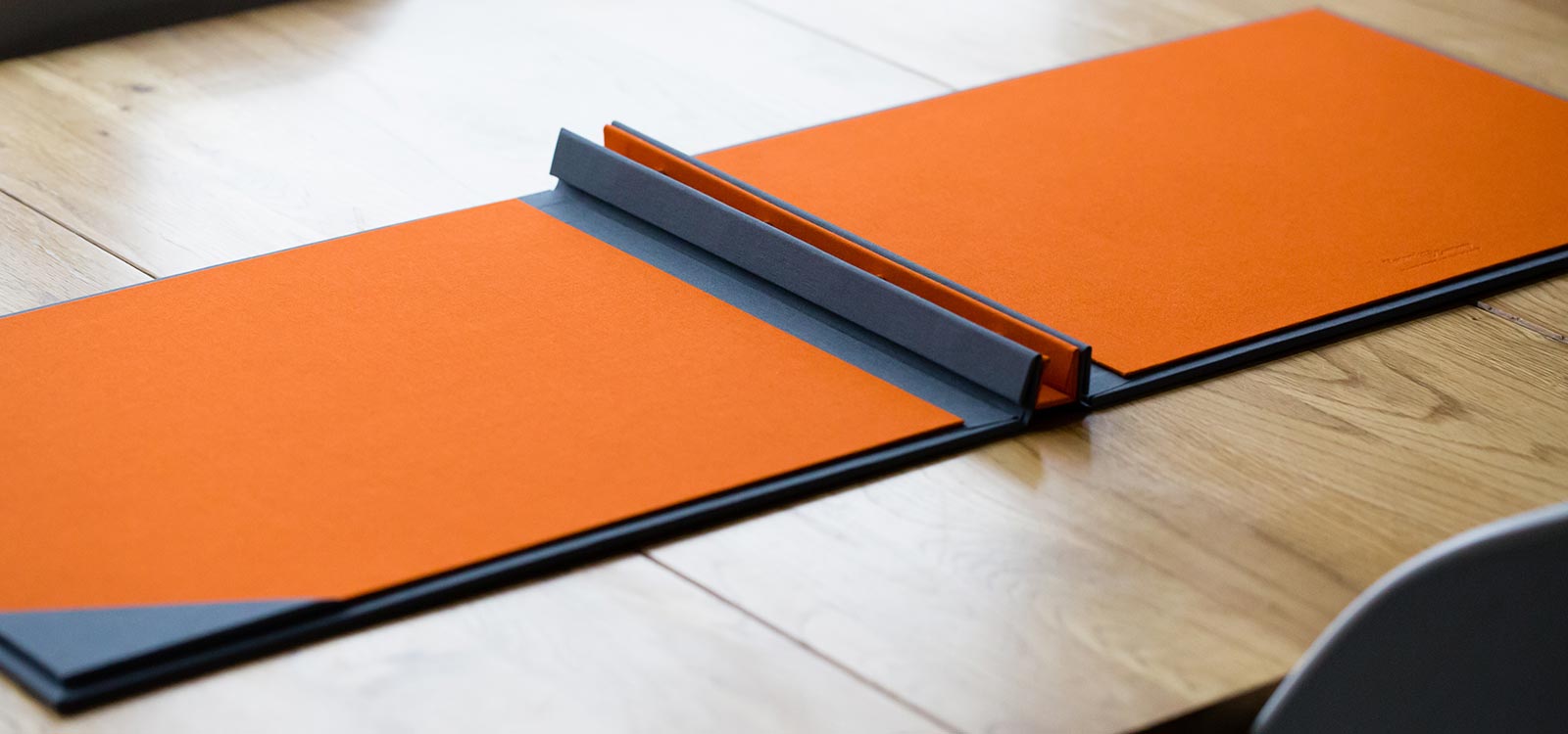 screw post portfolio book in orange and grey fabric for photographers designers and architects