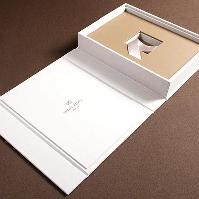 luxury high quality presentation box in beige fabric lying open on brown fabric for high end property development