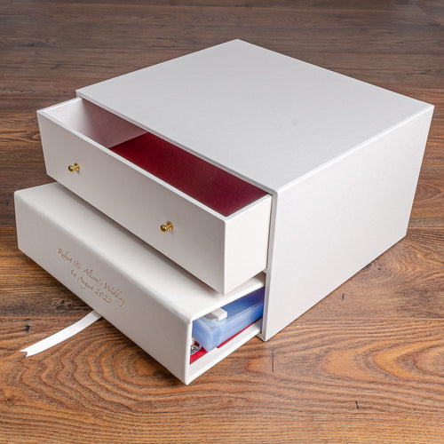 white keepsake box with drawer and white leather binder with gold foil embossing