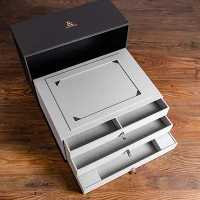 Custom made presentation box with three drawers a place for a presentation letter and foiled logos hand made by Hartnack and Co