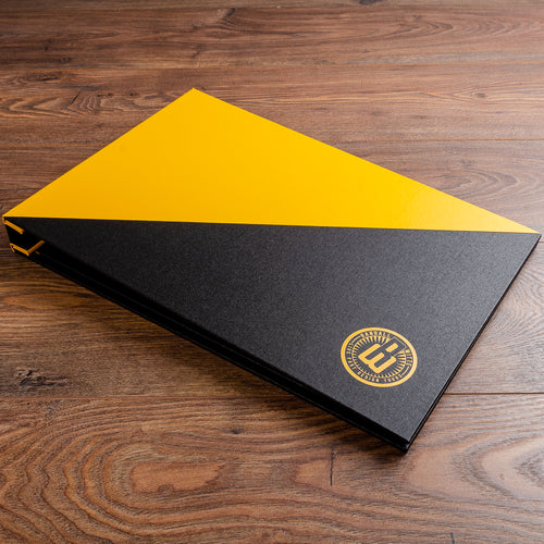 11x17 portfolio book in yellow and black fabric with yellow printed logo on the cover