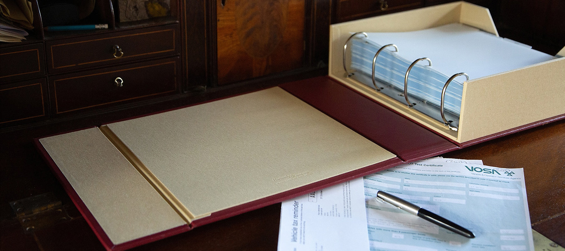 car document and history box file with car registration documents on desk