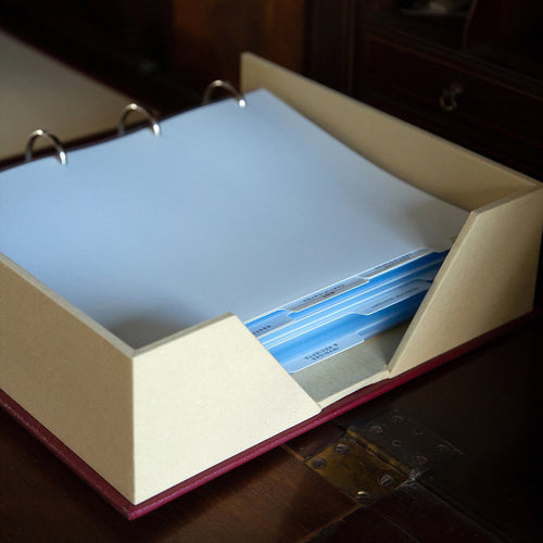 a large stack of paper and tabbed dividers in luxury box file binder