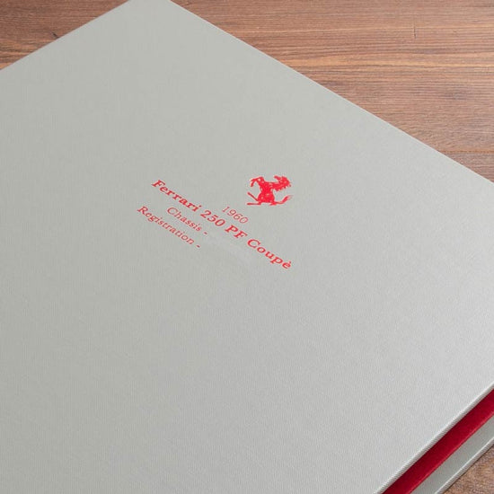 Red foil personalisation on the cover of a classic car history file