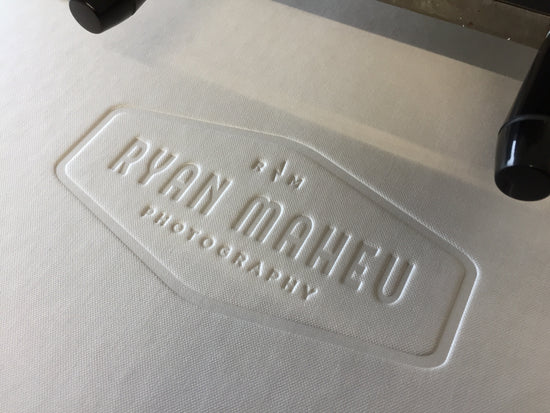 Example of a blind deboss logo on the cover of a photography portfolio book