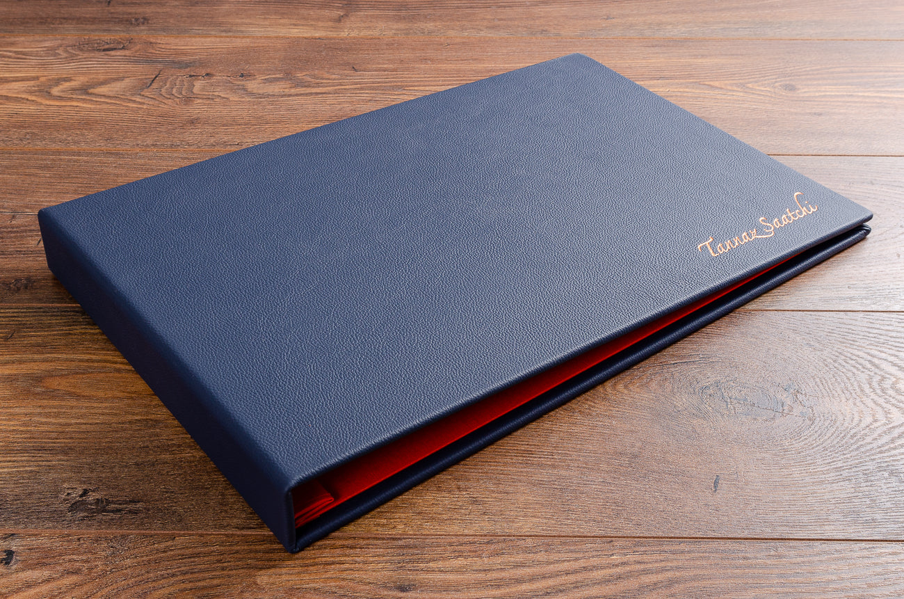 Leather portfolio book. Product is case bound screw post binder bound in blue leather. Size 11x17.  Personalisation foil embossing