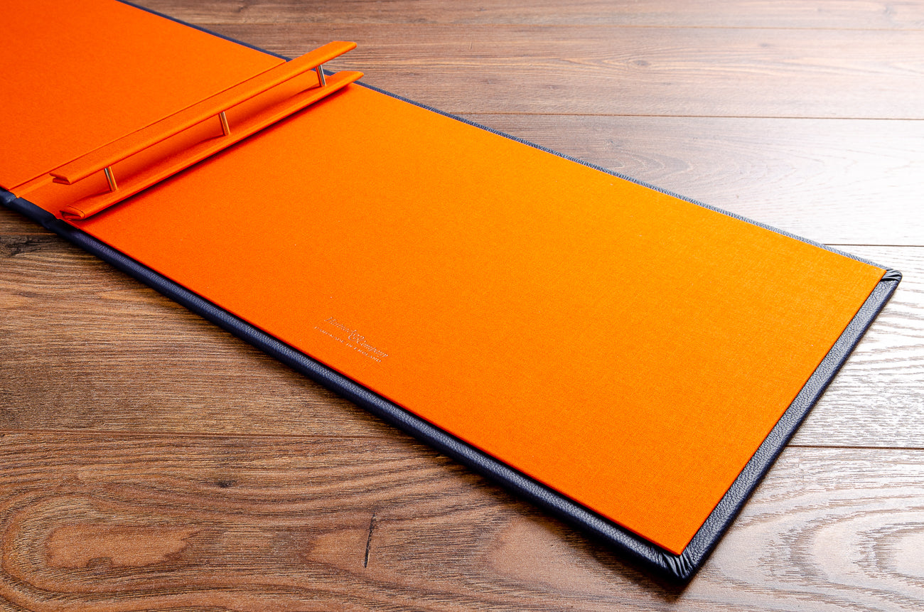 11x17 screw post portfolio book. Inner cover in Solo orange book cloth