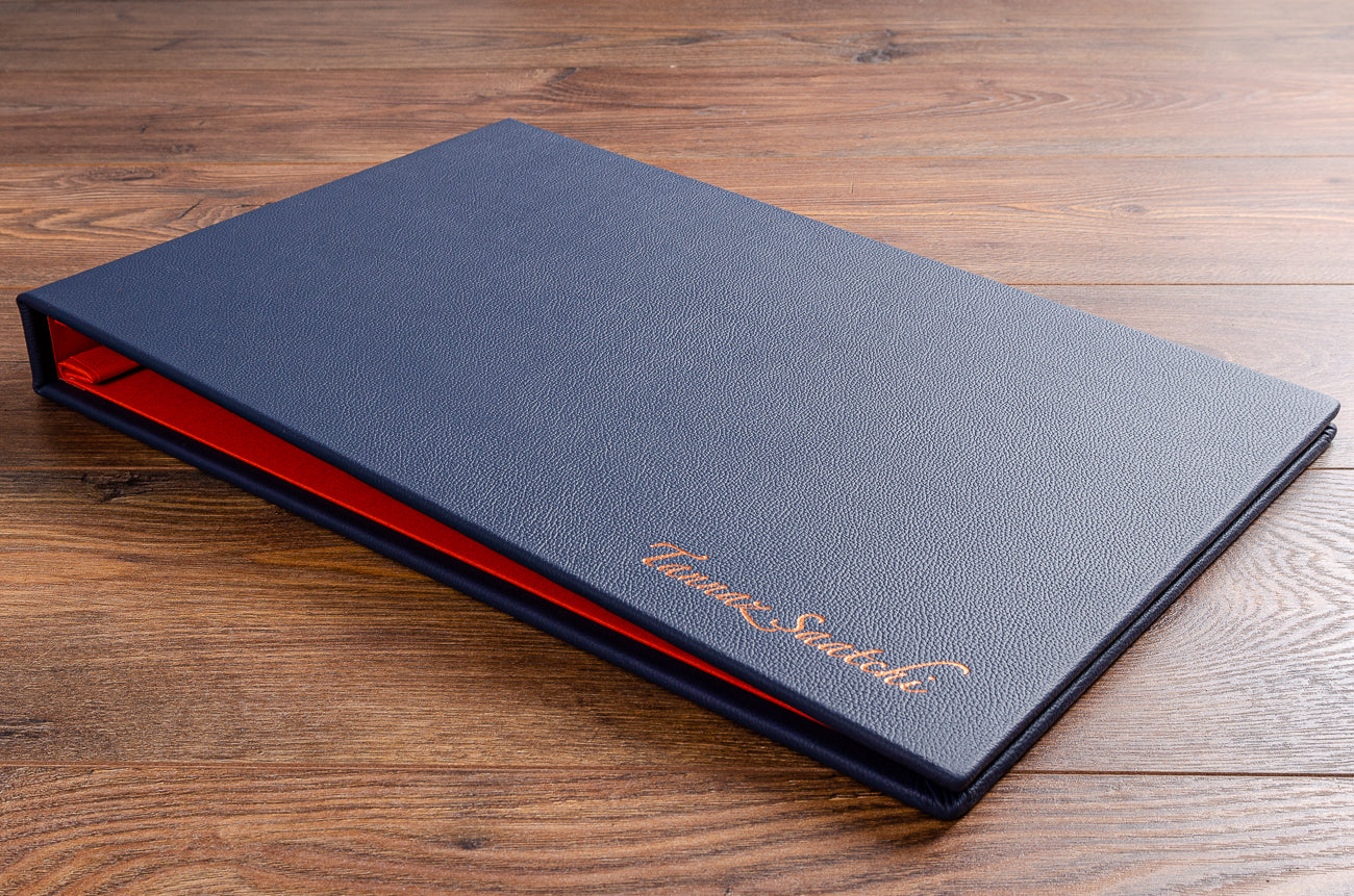 11x17 portfolio book bound in blue leather with copper foil embossing