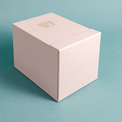 Custom made leather slipcase box personalised with gold foil embossed logo on the top and front flap