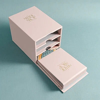 custom made leather slip case box with flap and personalised gold foil logo, together with three fabric swatch book personalised on the cover with foil emboss and fabric flash