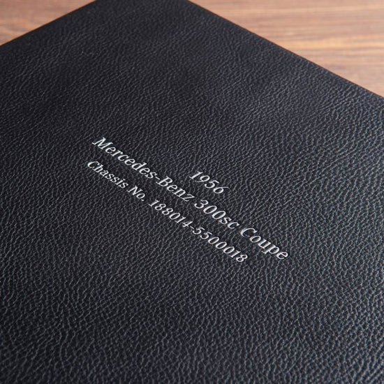 Silver embossing on the cover of a car document box