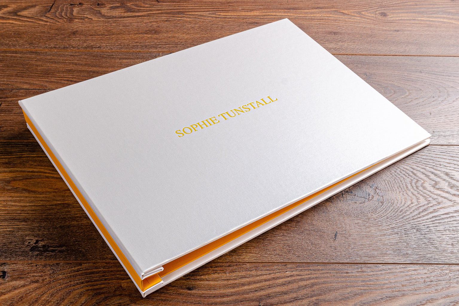 11x17 photography portfolio book in cool yellow and and white with yellow foil embossing