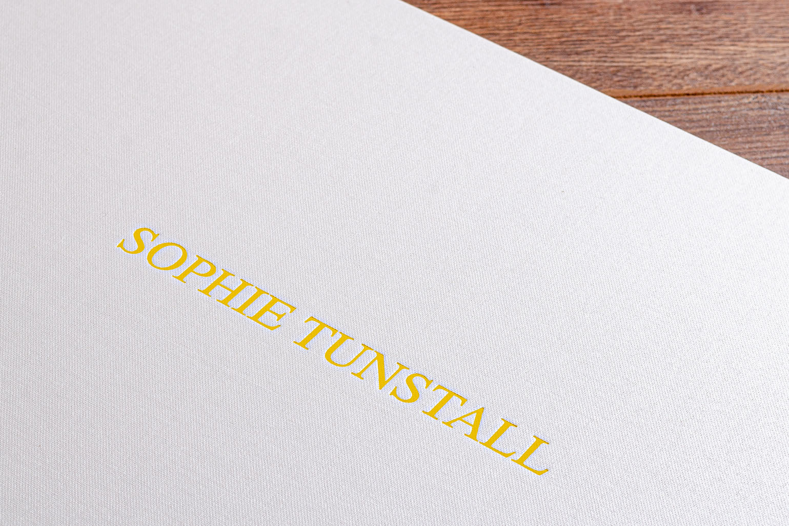 Personalised portfolio cover in yellow foil embossing on white cover