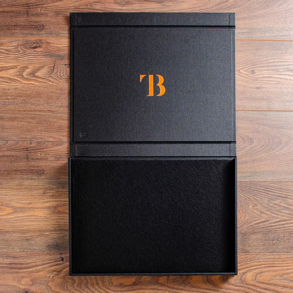 photographers print portfolio box in black buckram lying open with copper foil logo embossed on the inside cover - Gallery image 2