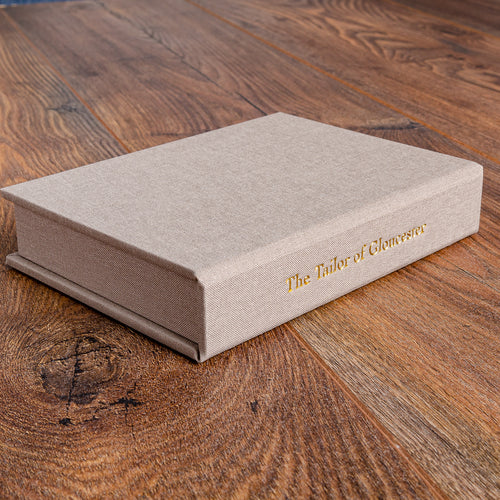 custom made solander clamshell box in beige fabric with gold foil stamping for early edition beatrix potter book
