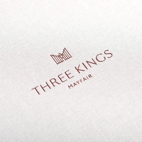 copper foil embossed logo onto beige book cloth