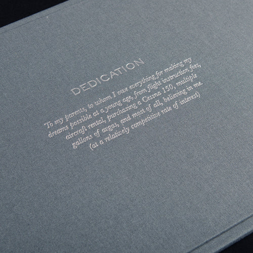 silver foil embossed dedication on grey fabric