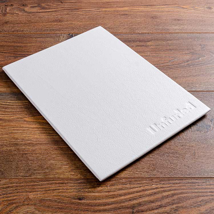luxury leather menu board in white leather with embossed logo on the front cover for luxury yacht 