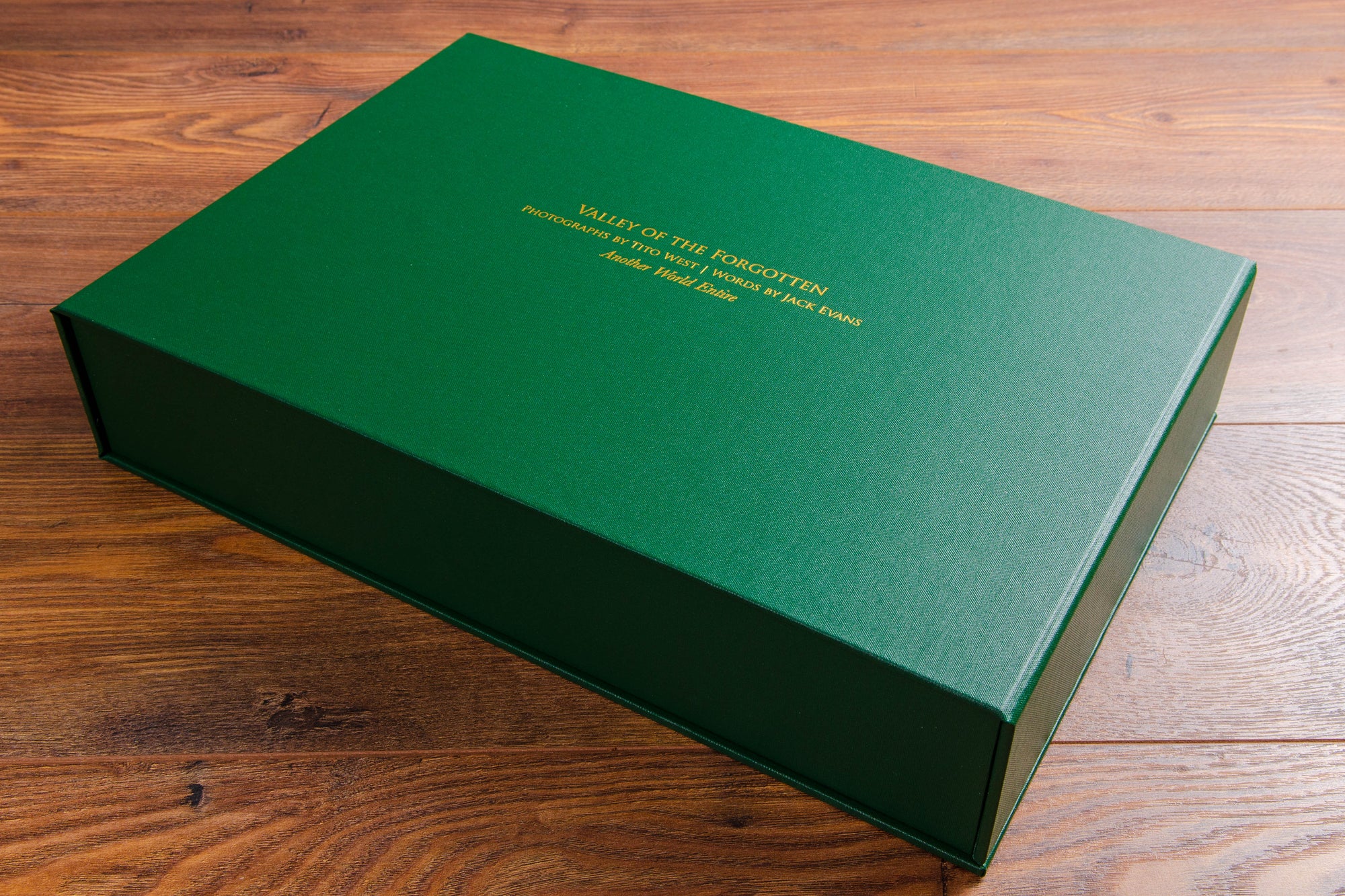 Portfolio box. Product - Clamshell box. Size is 11x17 inches. Colour is green buckram. Personalisation is full colour UV printing