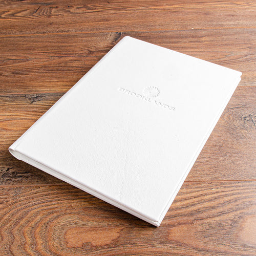 White leather menu cover with personalised embossed logo for luxury hotel restaurant in London