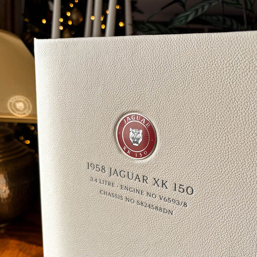 Leather bound box file with metal disk of Jaguar XK150 and silver foil embossing