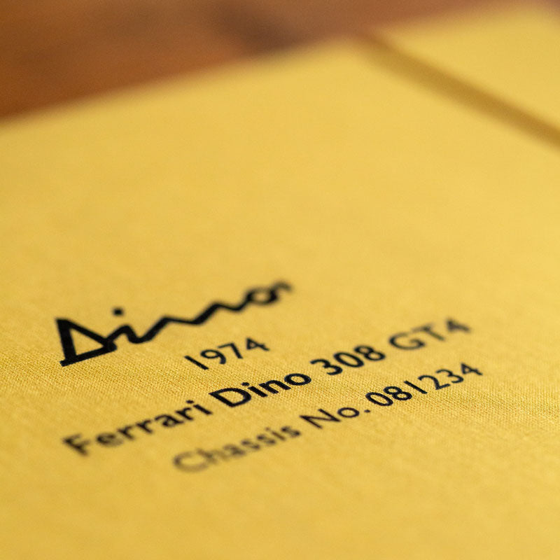 Close of detail of black foil embossed cover of car document and history file by Hartnack & Co. - Gallery image 5